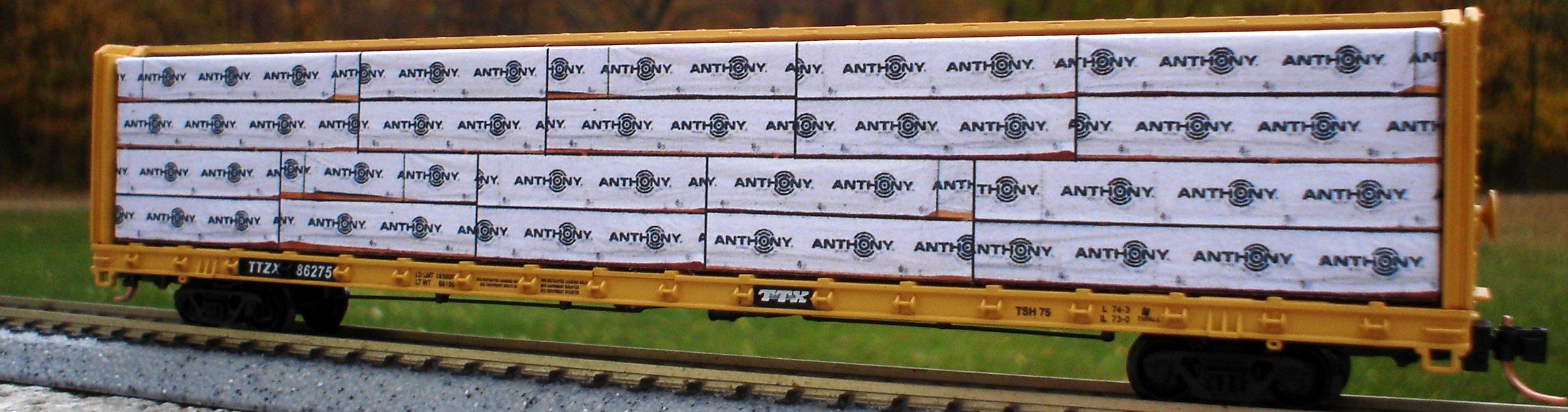 N Scale - Columbus Trainmaster - 72036N - Accessories, Load, Centerbeam,Wrapped - Painted/Lettered - Anthony Forest Products